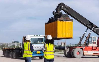 Container being lifted onto a truck